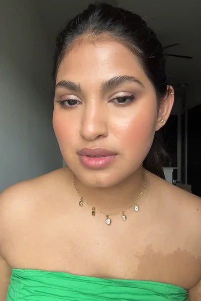 Muznah applying Glaze Craze Tinted Lip Serum in CINNAMON SUGAR (MAUVE PINK)